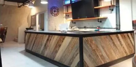 Café bar counter clad in herringbone reclaimed wood