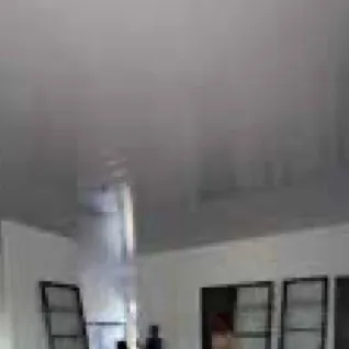 Room with white ceiling and black-framed windows