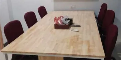 Solid-wood meeting table with office chairs