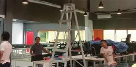 Workers with ladder in a newly furnished office