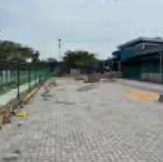 Completed paving block yard beside a warehouse